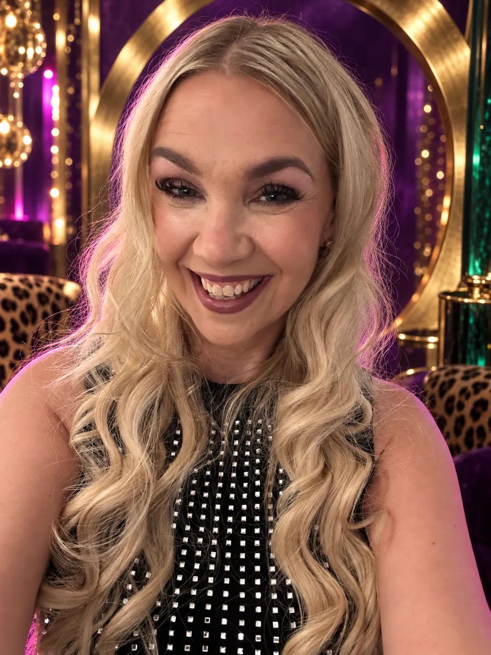 Jaclyn laughing in front of cheetah print chairs